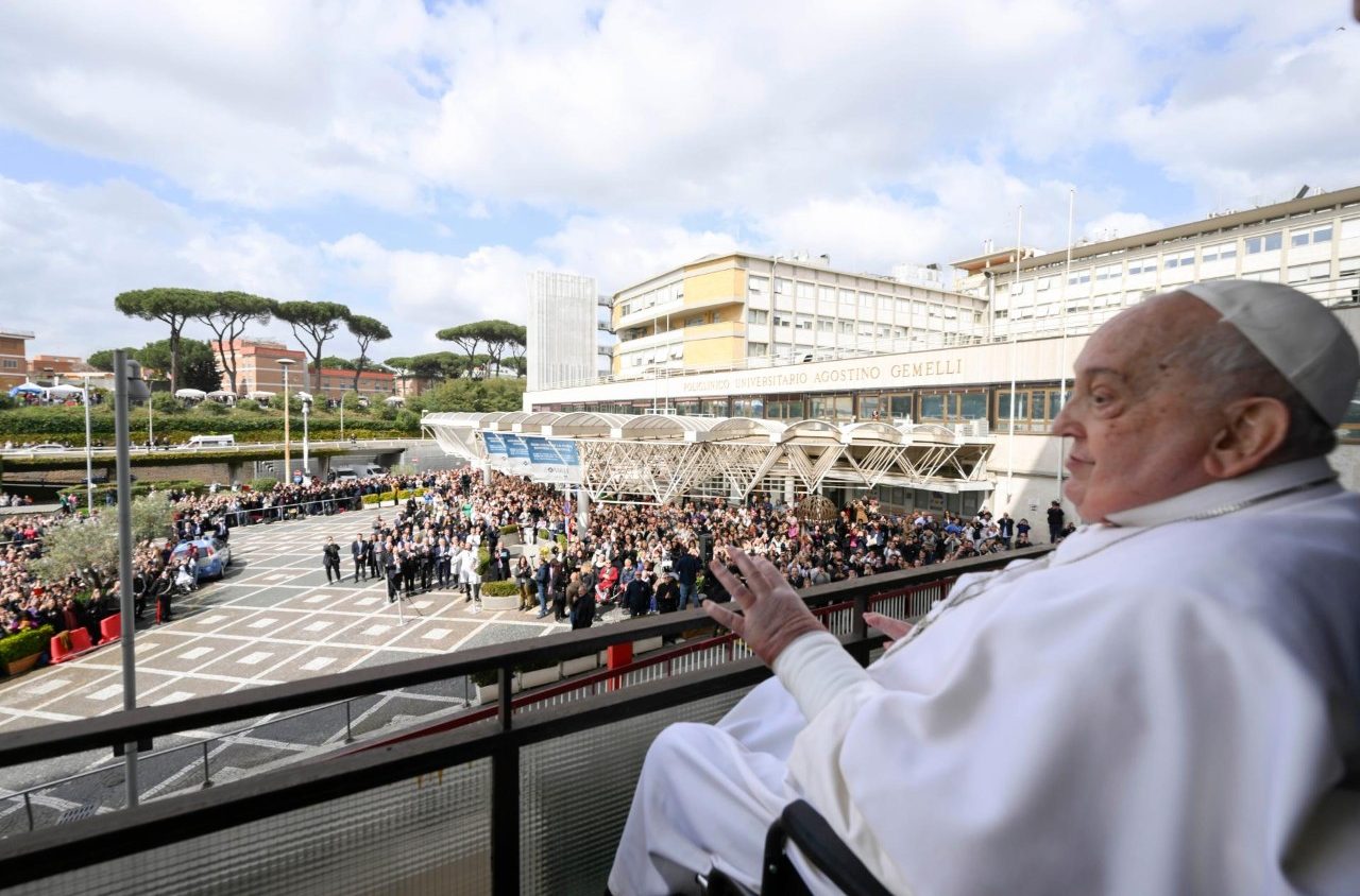 Paus Franciscus groet de mensen van op zijn balkon in het Gemelli-ziekenhuis.
