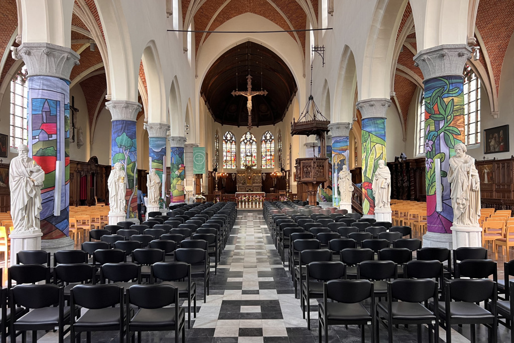 Rond de zuilen van de Sint-Corneliuskerk hangen kleurrijke doeken verwijzend naar het werk van Antoon De Clerck.