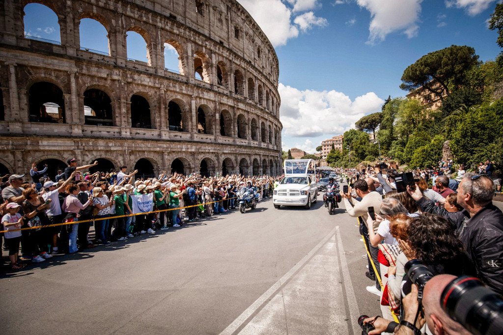 De tocht leidt onder meer langs het Colosseum, waar de toeschouwers rijen dik staan.