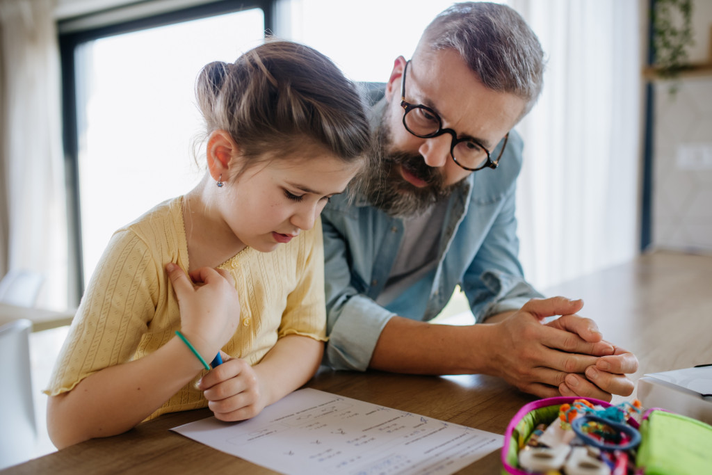 Opgeleide vrijwilligers helpen kwetsbare kinderen thuis met hun huiswerk.