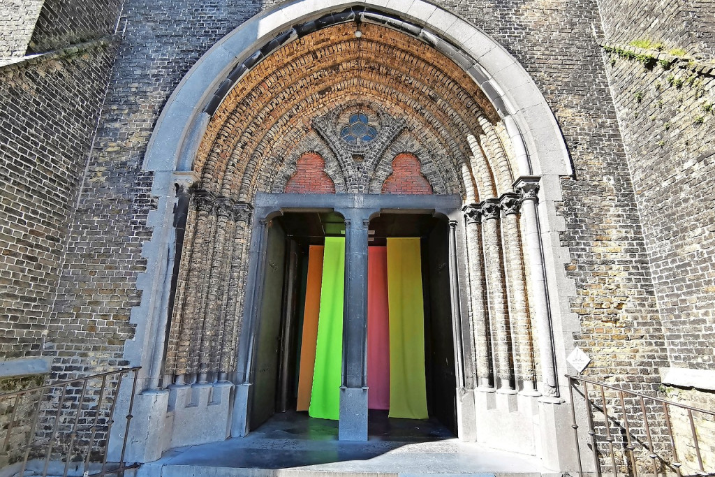 Bij het betreden van de kerk laveert de bezoeker tussen kleurrijke doeken. © Ann Benoot