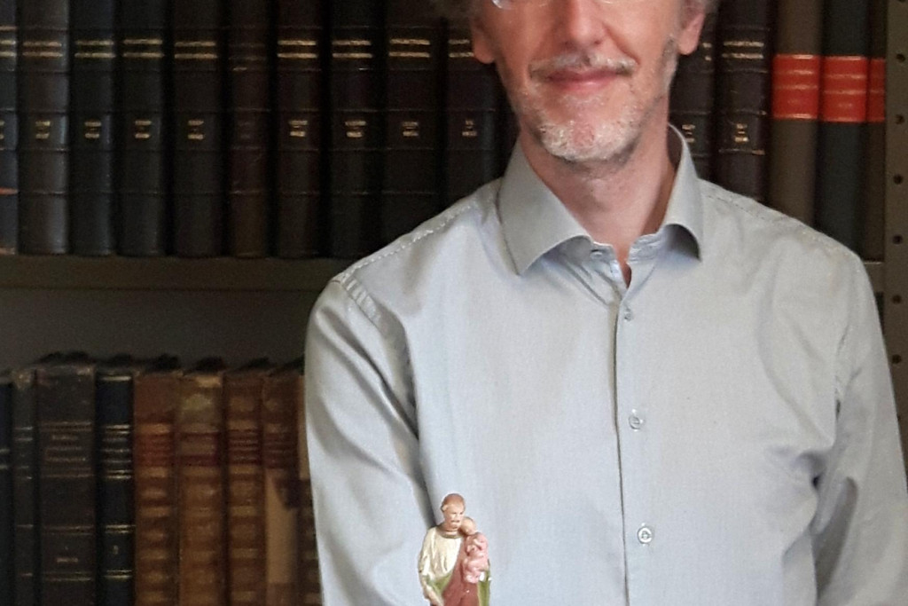 Archivaris Gerrit Vanden Bosch met een beeldje van de heilige Antonius van Padua, patroon van verloren voorwerpen. 'Komt altijd van pas wanneer we een stuk niet vinden in het archief!'