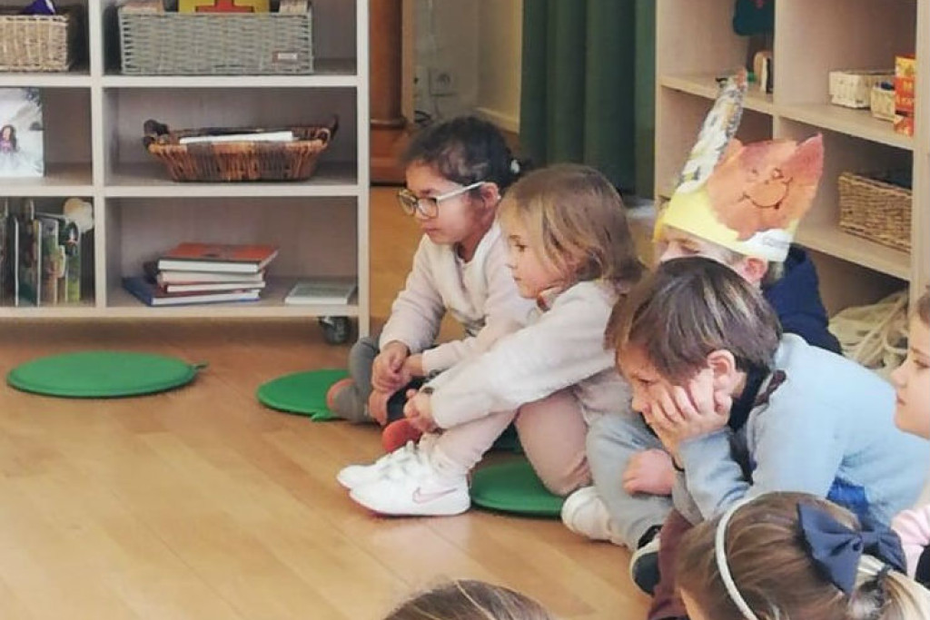 Kinderen luisteren geboeid naar het Godly Play verhaal in de Godly Play ruimte van Internaat Kinderland in Kortrijk