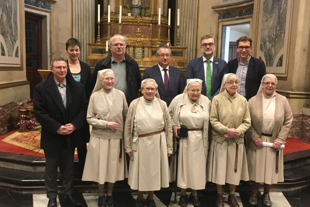 Prior Martin, zusters van het Engels Klooster met rechts zuster Aline; achteraan v.l.n.r. Doenja Van Belleghem (coördinator), Nico Blontrock (schepen), Dirk De fauw (burgemeester), Peter De Wilde (Toerisme Vlaanderen) en Franky Demon (schepen)