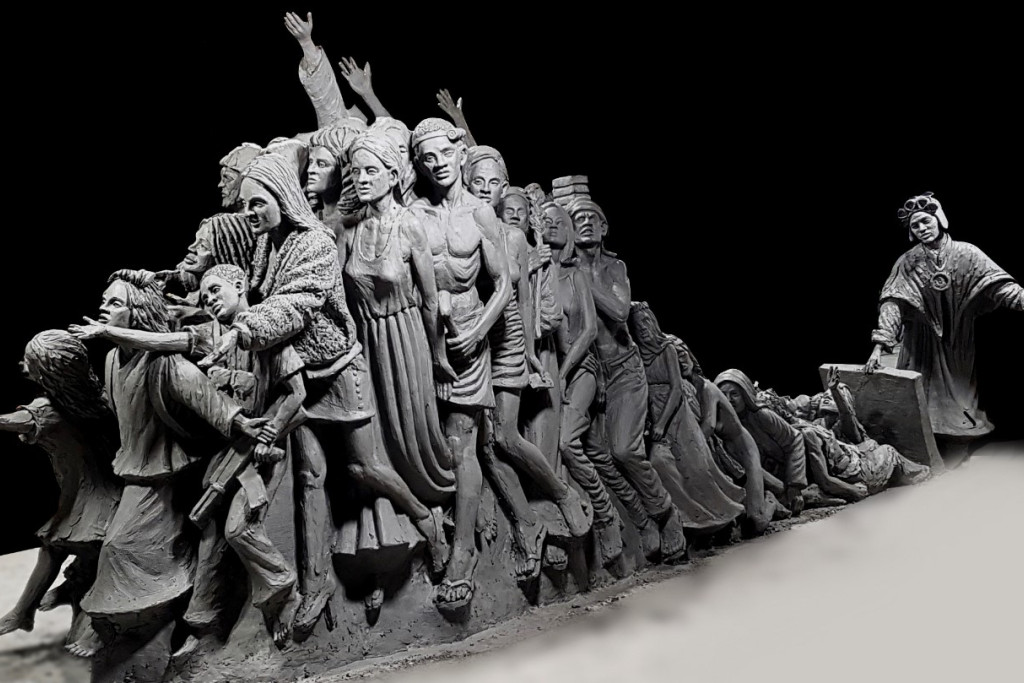 Timothy Schmalz, 'Let the Oppressed Go Free'. Achteraan herken je de heilige Bakhita, die een luik naar vrijheid opent voor alle hedendaagse slachtoffers van mensenhandel en dwangarbeid.