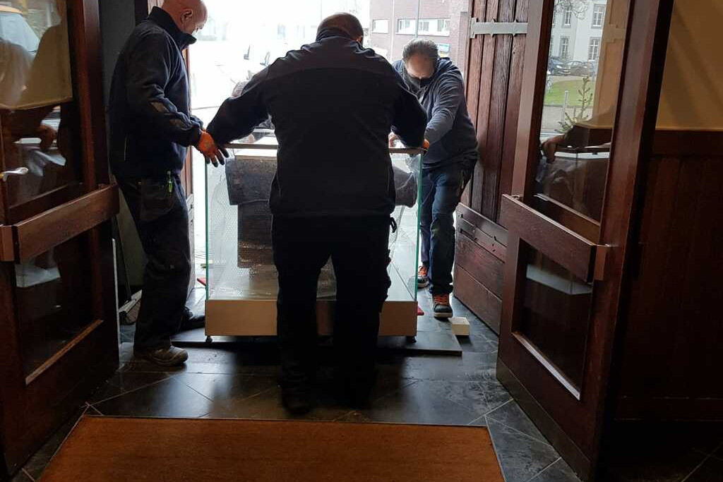 Het boomgraf wordt de kerk binnengebracht