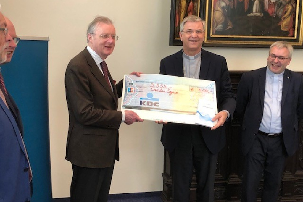 Mgr. Johan Bonny overhandigde een cheque van 3.555 euro aan Frank De Coninck, voorzitter van Caritas International, en François Cornet, directeur-generaal van Caritas International, ter ondersteuning van het werk van Caritas in Syrië